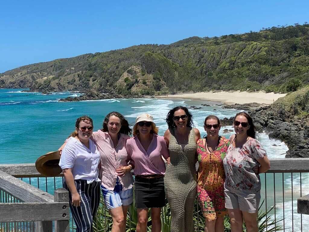 Rachael Keenan standing with her colleagues at the ocean.